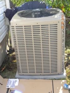 An outdoor air conditioning unit being serviced by Ketzenberg Heating & Cooling in Avenel, NJ.