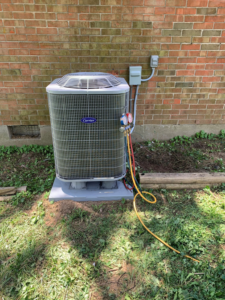 An outdoor AC condenser unit being serviced by Legacy Heating & Air Conditioning LLC in Louisville, KY