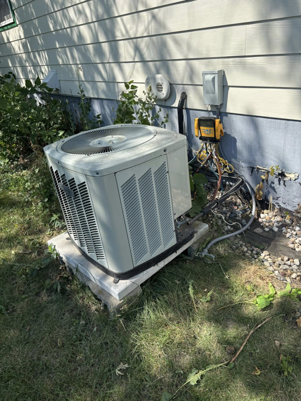 An outdoor air conditioning unit being serviced by Premier HVAC/ Small appliance in Brooklyn, NY.
