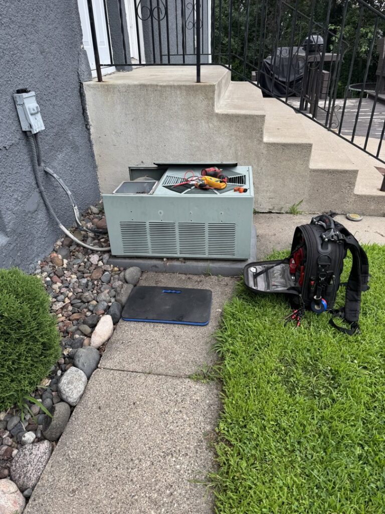An outdoor air conditioning unit undergoing service or repair by HVAC KING LLC in Maple Grove, MN