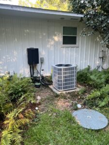 An outdoor AC unit and a tankless water heater installed on the side of a home by Circle L Heating and Cooling LLC in Atmore, AL.