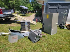 An outdoor AC unit installed under a deck by S&B heating and cooling in Florence, KY.