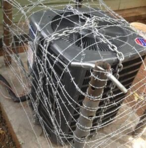 An outdoor air conditioning unit secured with barbed wire, serviced by All Metro Air Conditioning in Apache Junction, AZ.