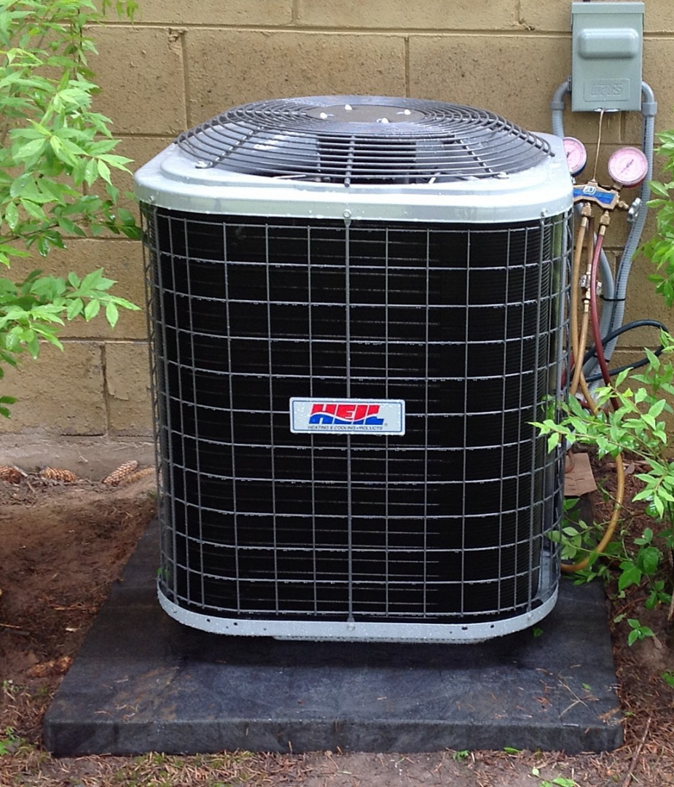 An outdoor air conditioning unit with service gauges connected by an HVAC Logistics technician in Albuquerque, NM