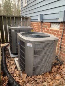 Two outdoor AC units installed next to a residential building by Air Energy Solutions in North Chesterfield, VA