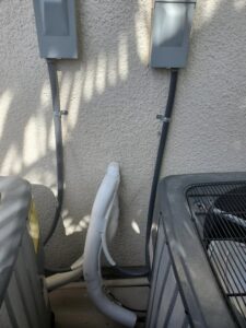 Multiple outdoor air conditioning units with electrical conduits and insulated lines installed by Sahara Air Conditioning & Heating in Las Vegas, NV
