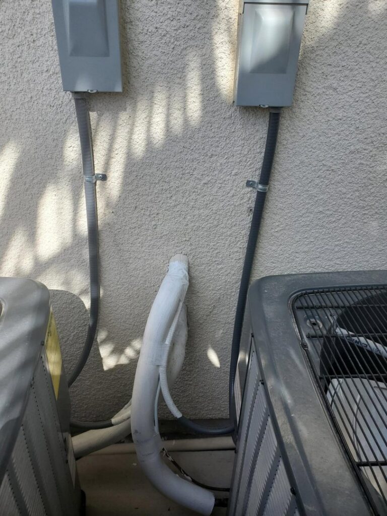 Multiple outdoor air conditioning units with electrical conduits and insulated lines installed by Sahara Air Conditioning & Heating in Las Vegas, NV
