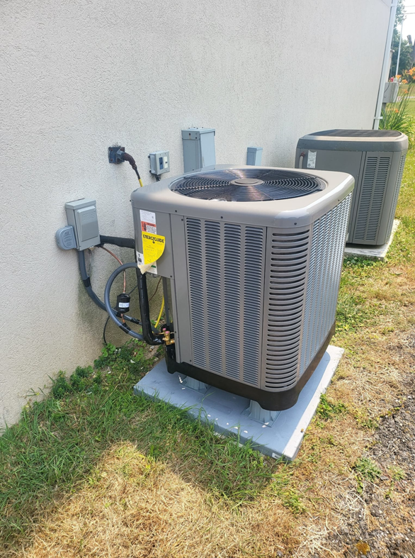 Two outdoor air conditioning units installed by Zibi Construction in Mount Prospect, IL, ready for cooling.