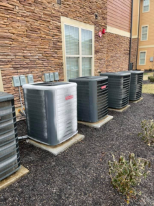 A row of outdoor residential or commercial AC units, one showing frost, serviced by Wright Air Care in Murfreesboro, TN.