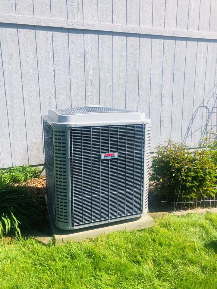 A newly installed outdoor air conditioner condenser unit by SK Heating and Cooling in Bala Cynwyd, PA
