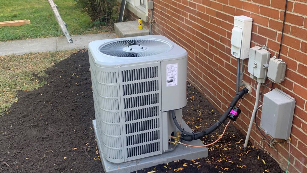 A newly installed outdoor air conditioning unit next to a brick house by Family First Heating and Cooling Repair LLC in Toledo, OH.