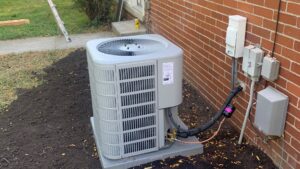 A newly installed outdoor air conditioning unit next to a brick house by Family First Heating and Cooling Repair LLC in Toledo, OH.