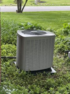 An outdoor air conditioning unit installed at a residential property by Isaac Heating & Air Conditioning in Rochester, NY.