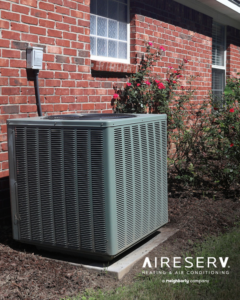 An outdoor air conditioning unit installed next to a brick residential house by Aire Serv of Rochester, NY