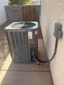 A modern outdoor air conditioning unit installed next to a home by S&S Mechanical in St. George, UT