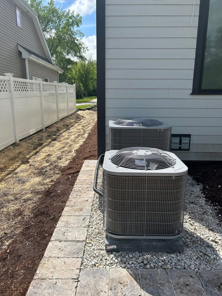 Two outdoor air conditioning units installed next to a residential home by Alan Energy Services in Naperville, IL