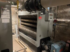 An outdoor Bosch HVAC unit installed next to a brick building by Mason Mechanical Services LLC HVAC Frederick Md in Jefferson, MD.