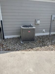A Bryant outdoor HVAC condenser unit installed next to a building by Carpenter Mechanical in Columbus, OH.