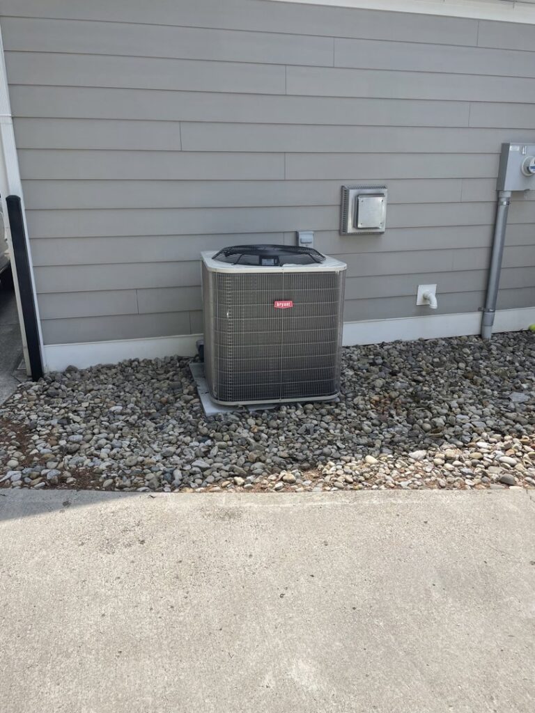 A Bryant outdoor HVAC condenser unit installed next to a building by Carpenter Mechanical in Columbus, OH.