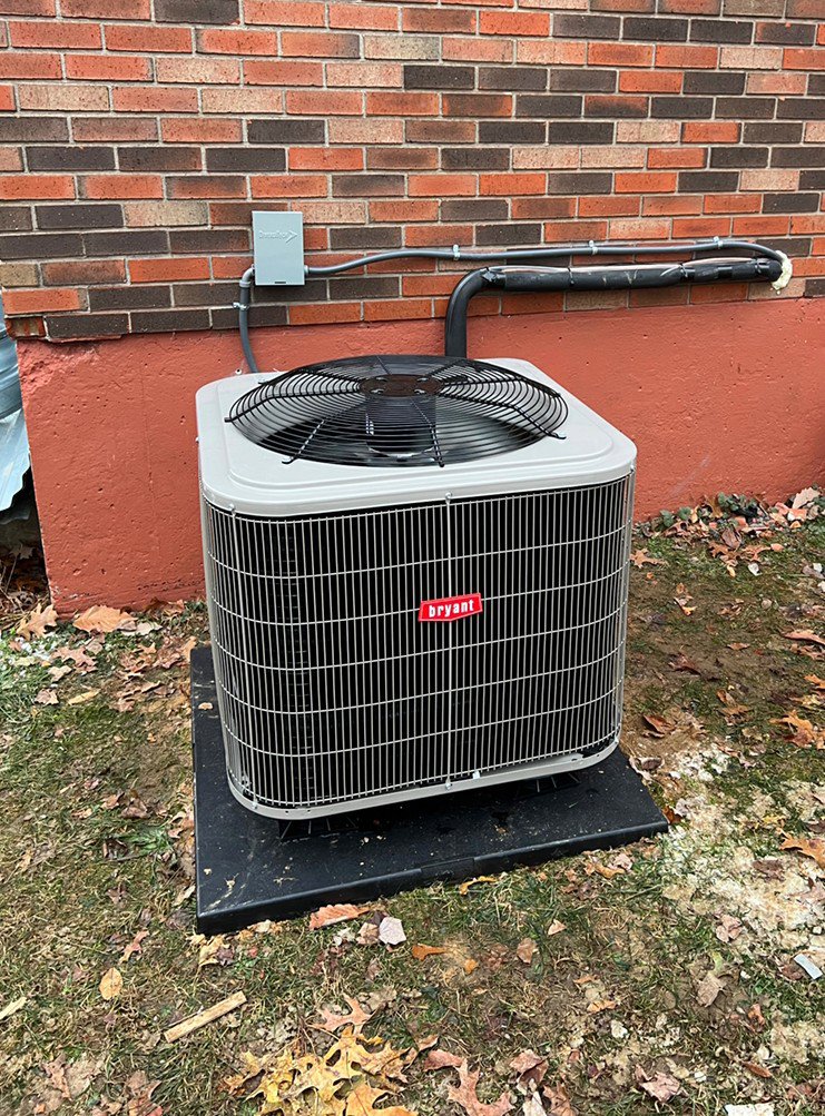 An outdoor Bryant HVAC unit installed next to the side of a house by Madison HVAC/R, Inc in Richmond, KY.