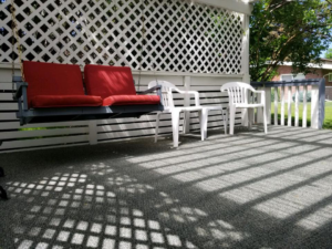 Outdoor carpet installed on a patio with a swing, by Warehouse Flooring in Great Falls, MT