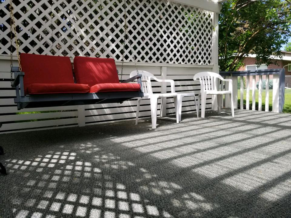 Outdoor carpet installed on a patio with a swing, by Warehouse Flooring in Great Falls, MT
