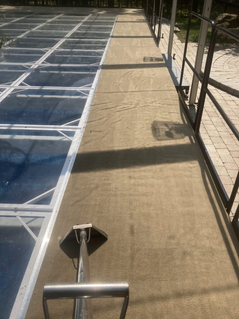 Outdoor carpet or turf being professionally cleaned, showing a clean section by TCK Carpet Cleaning in Indianapolis, IN.