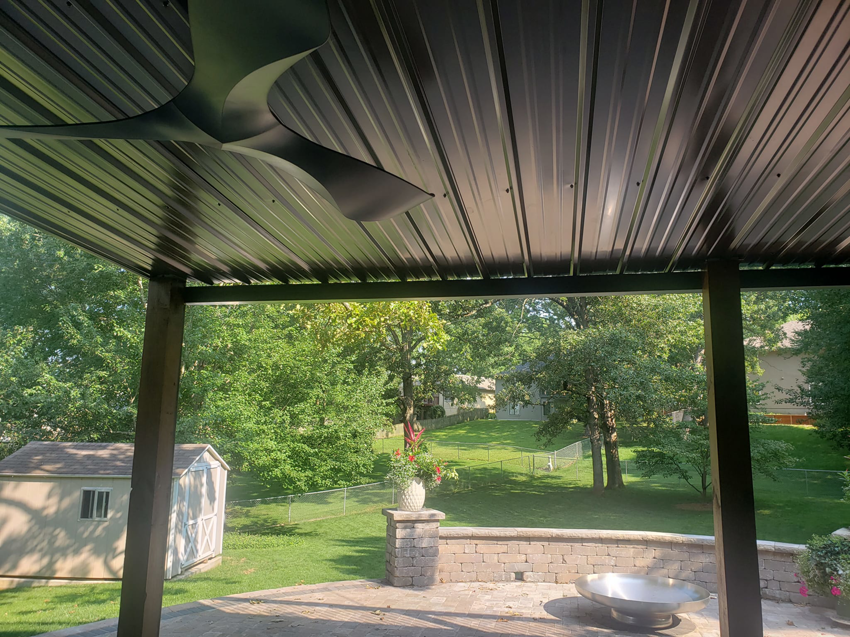 An outdoor ceiling fan installed on a patio with a metal roof by BIG Services in Springfield, MO.