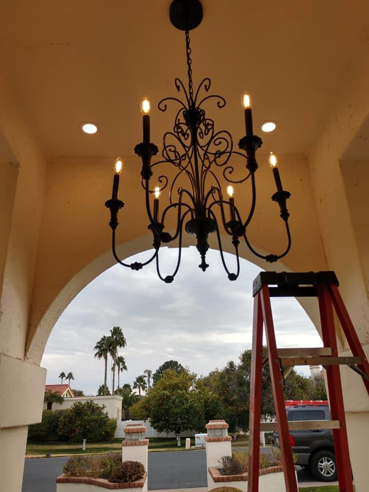 An ornate outdoor chandelier and recessed lighting installed under an archway by R&M Electric LLC in Gilbert, AZ.
