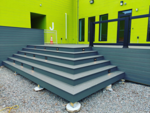 Outdoor deck stairs featuring modern integrated step lighting installed by Island Power Company LLC in South Kingstown, RI.