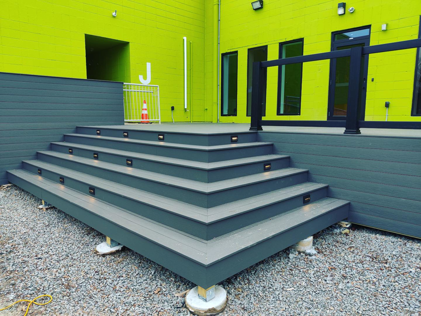 Outdoor deck stairs featuring modern integrated step lighting installed by Island Power Company LLC in South Kingstown, RI.