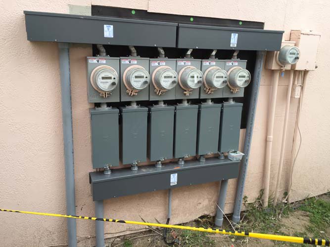 Outdoor electric meters and service panels installed by Christensen Electric in Galveston, TX.