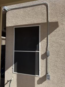 Outdoor electrical box and outlet installation on a stucco wall by Dependable Sparky Electric in Peoria, AZ