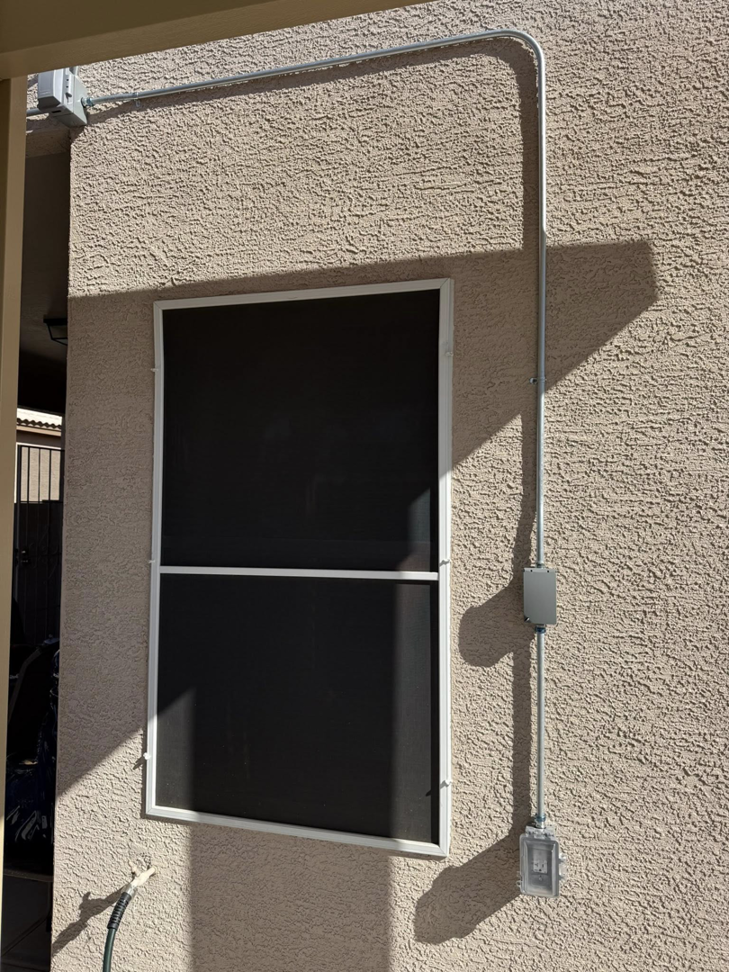 Outdoor electrical box and outlet installation on a stucco wall by Dependable Sparky Electric in Peoria, AZ