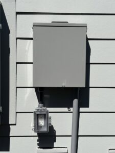 An outdoor electrical box with a weatherproof outlet installed by Tenax Electrical Company in Jacksonville, FL.