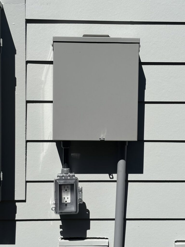 An outdoor electrical box with a weatherproof outlet installed by Tenax Electrical Company in Jacksonville, FL.