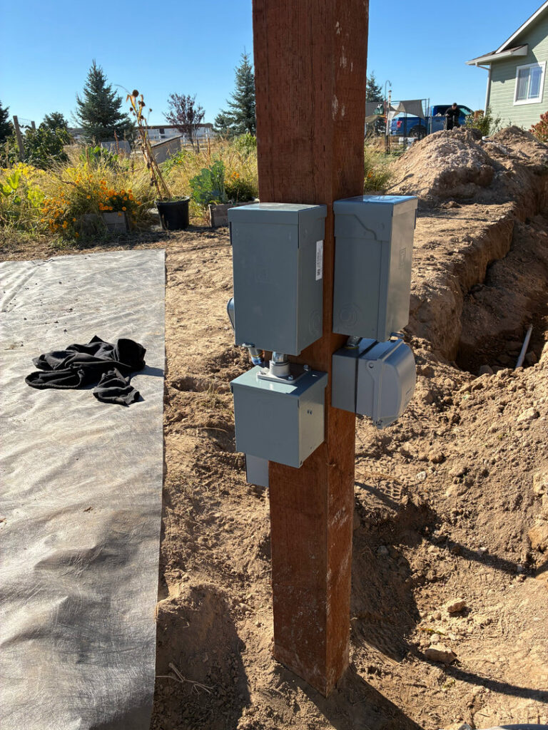 Outdoor electrical boxes mounted on a post during installation by Tier 1 Electric in Boise, ID