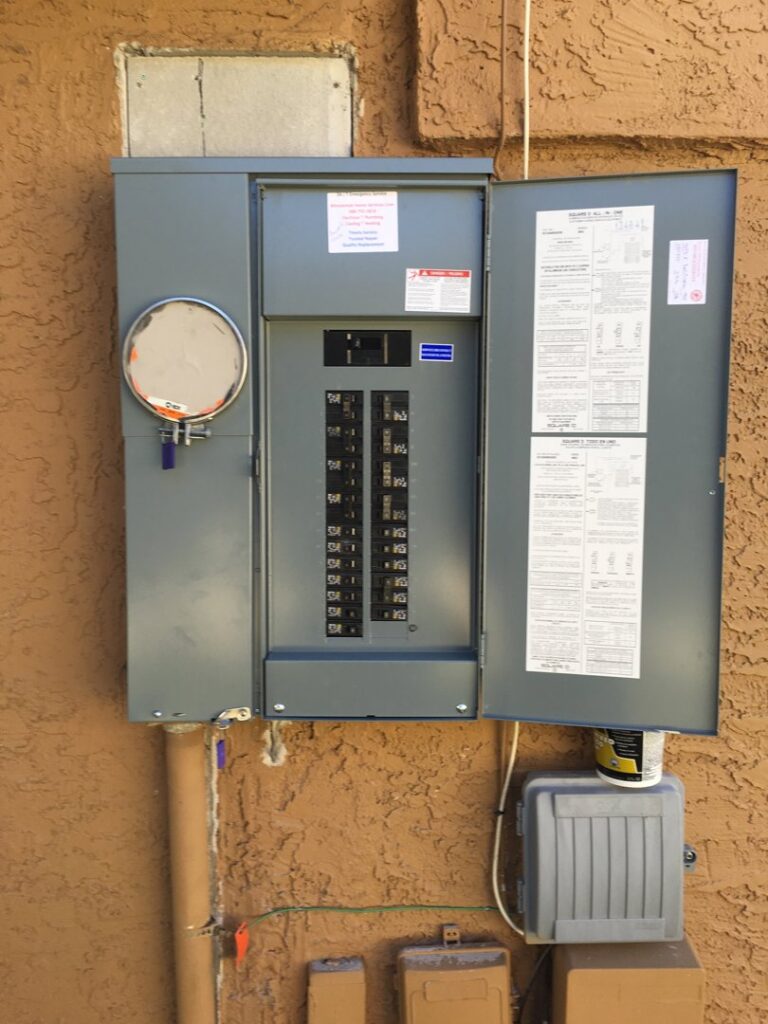 An open outdoor electrical breaker panel on a home, serviced by Minuteman Home Services in Mesa, AZ