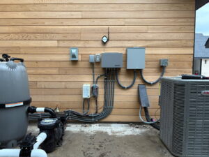 Complex outdoor electrical conduit and junction box installation next to a pool pump and HVAC unit by Mattox Electric, LLC in Dallas, TX.
