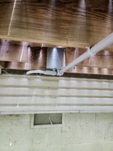 Outdoor electrical conduit and junction box installed under a deck by ABS Electrical Services in Rogers, AR.