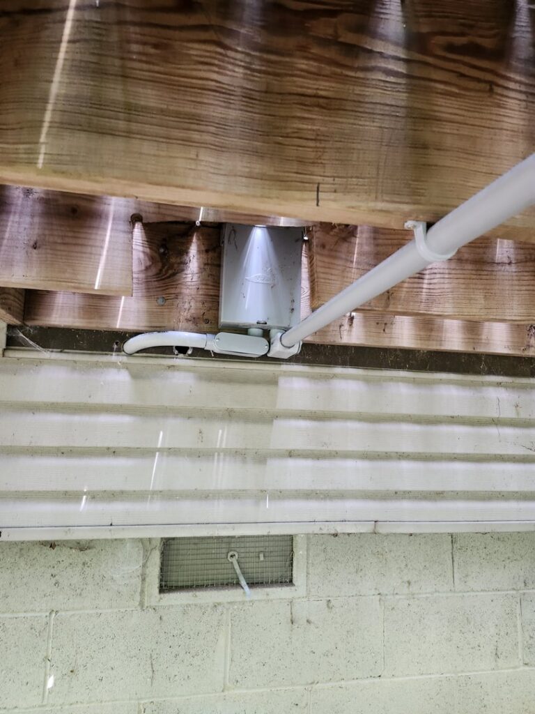 Outdoor electrical conduit and junction box installed under a deck by ABS Electrical Services in Rogers, AR.