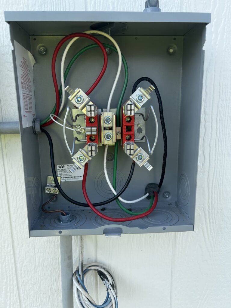 Close-up of an outdoor electrical disconnect box with neatly wired connections by Amped Electric in Virginia Beach, VA.