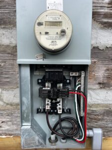 An outdoor electrical meter and main disconnect panel installed by Ozzy Electric in Jacksonville, FL.