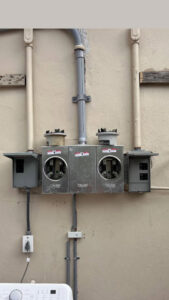 An outdoor electrical meter bank installation on a building exterior by Krakkom Electric in Sunrise, FL.