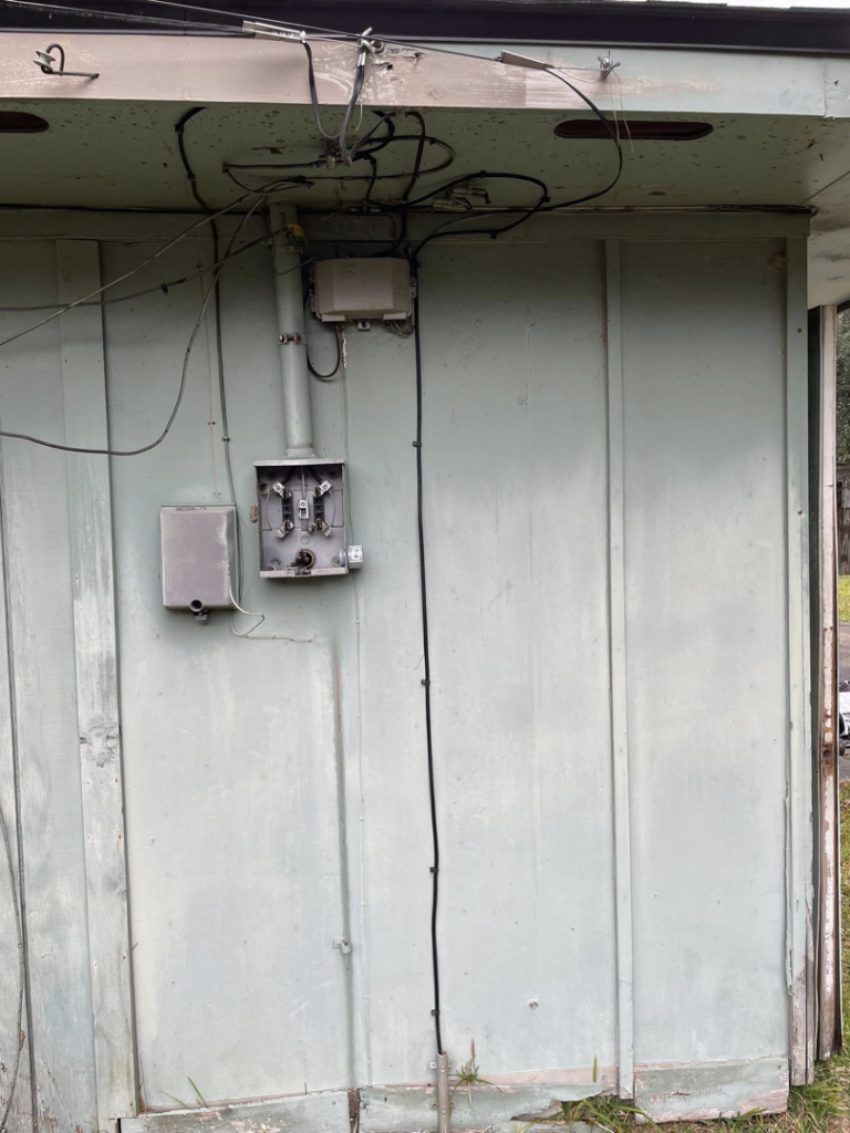 An outdoor electrical meter box and conduit installation on the side of a building by Savoski's Electrical & AC, LLC in Sunset, LA