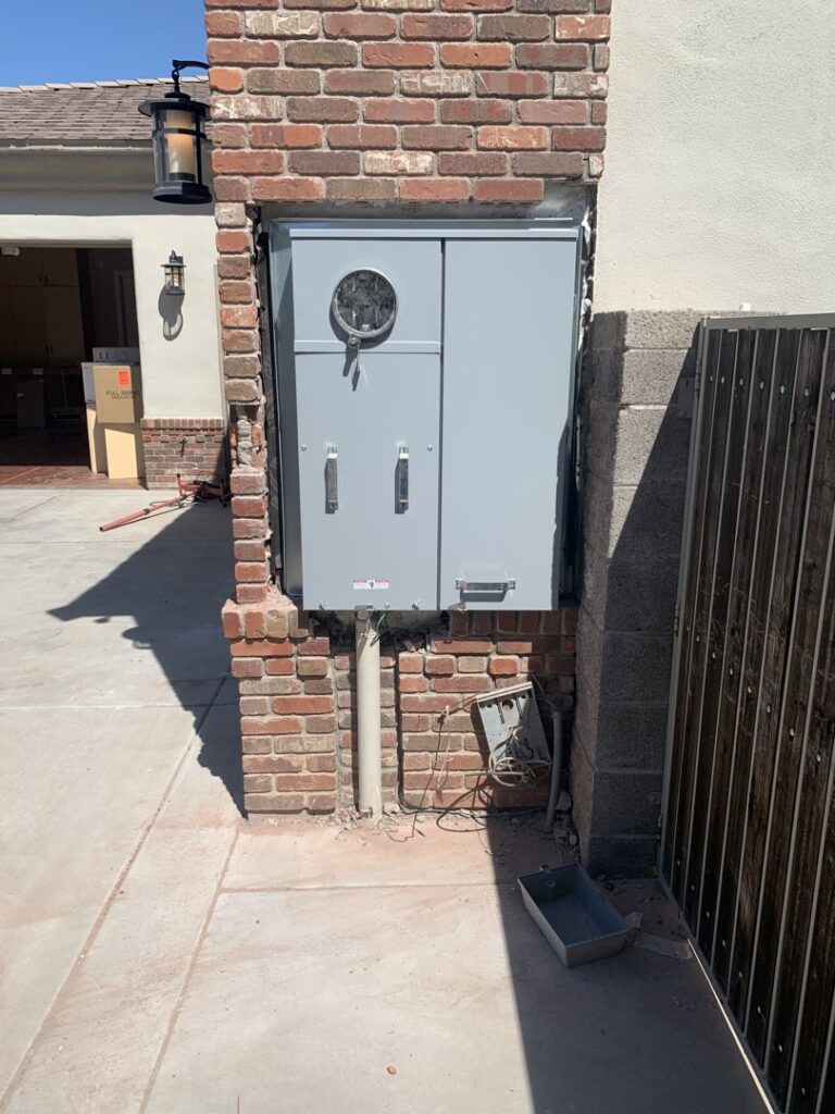 Outdoor electrical meter box and conduit installed on a brick wall by Silo Electric in Gilbert, AZ