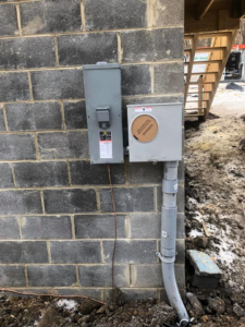 Outdoor electrical meter base and disconnect switch installed by Jon Chamberlain Electrical Services in Saxton, PA.