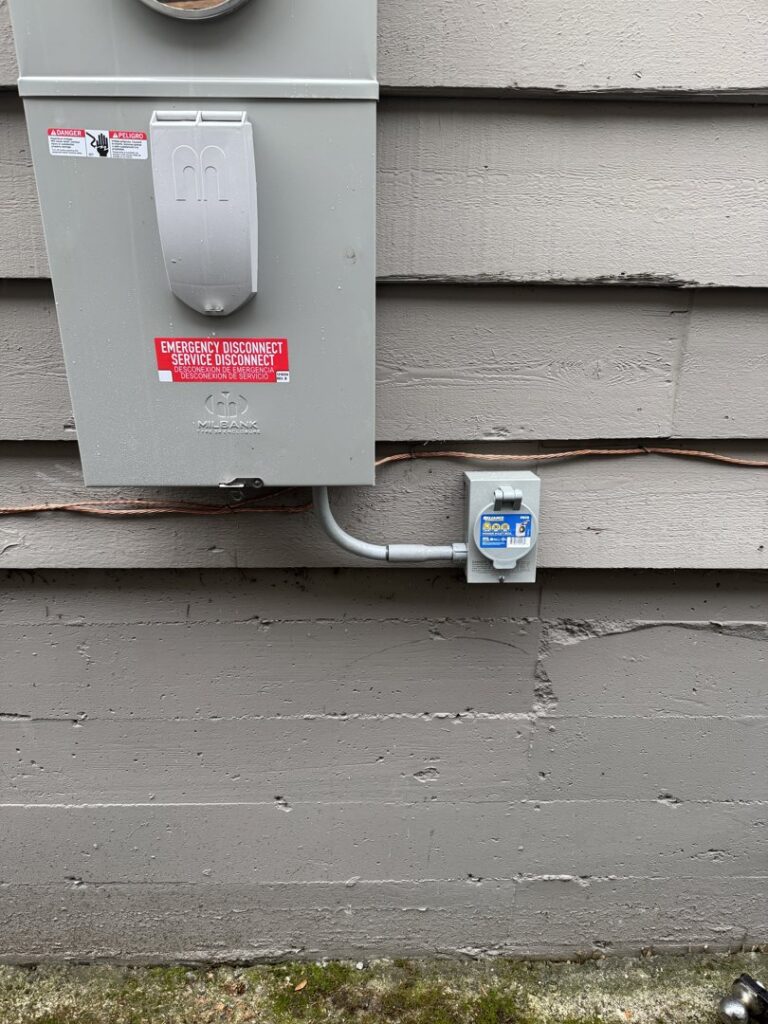 An outdoor electrical meter box and emergency disconnect switch installed by OutToday Electrical, Heating, Plumbing, and Air in Bellevue, WA