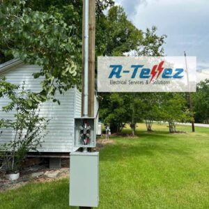 An outdoor electrical meter base and conduit installed on a utility pole by A-Tellez Electrical Services & Solutions L.L.C in Houston, TX.