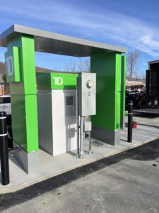 An outdoor electrical meter and conduit system installed next to a TD bank building by Peeler Electric Light & Power in Merrimack, NH.